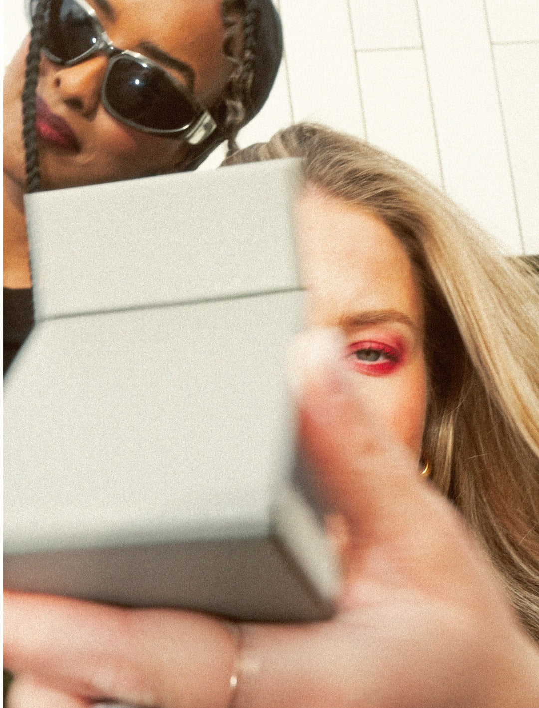 Girl holding pocket mirror